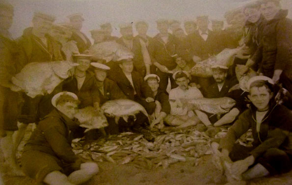 Men of HMS Hermione with a large catch of fish